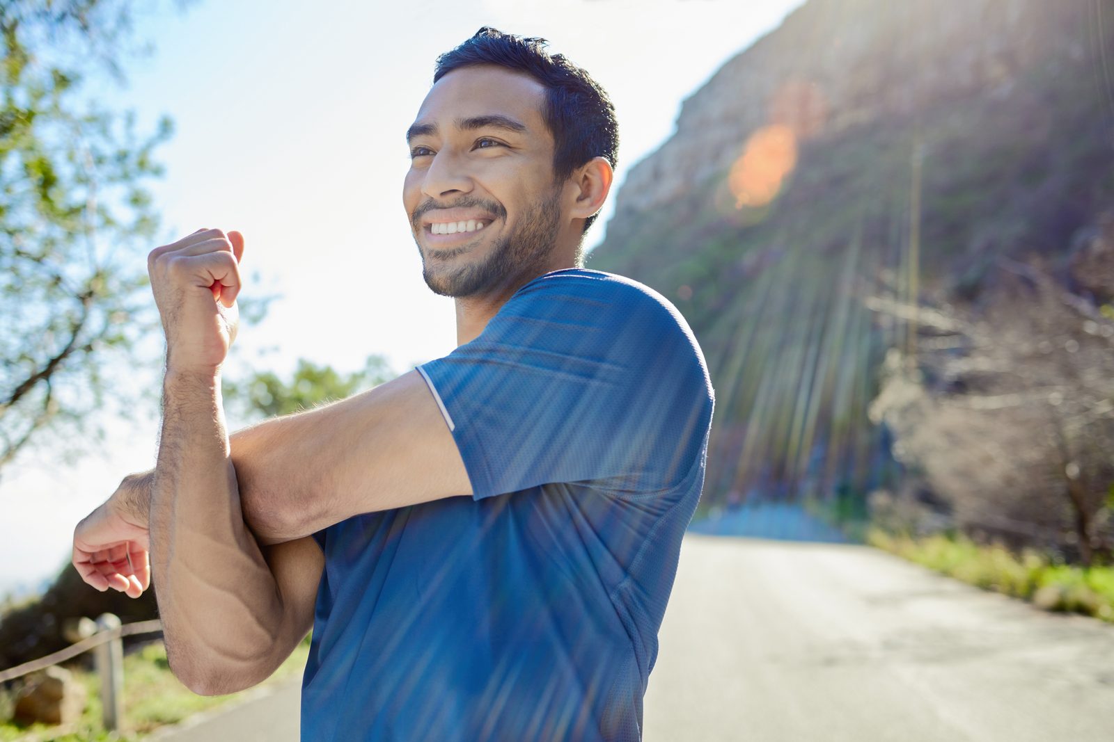 Man in his 40s feeling strong and energetic outdoors